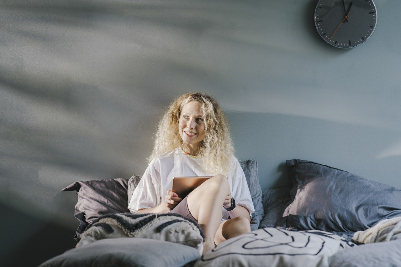How can I comfortably watch my iPad in bed?